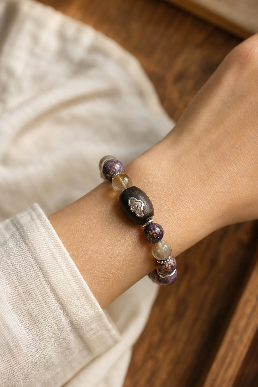 Five Elements Ebony and Purple Gold Sand Bracelet worn on wrist in natural light
